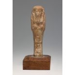Ushebti; Egypt, Late Antique, Ptolemaic period, 2nd-1st century BC.Brown faience. Wooden base.