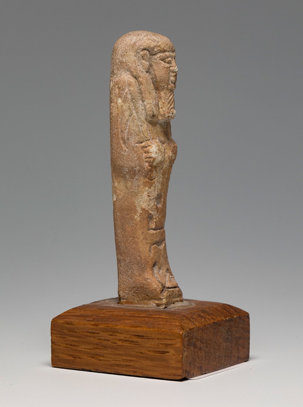 Ushebti; Egypt, Lower Egypt, Ptolemaic period, 2nd-1st century BC.Brown faience. Wooden base. - Image 3 of 4