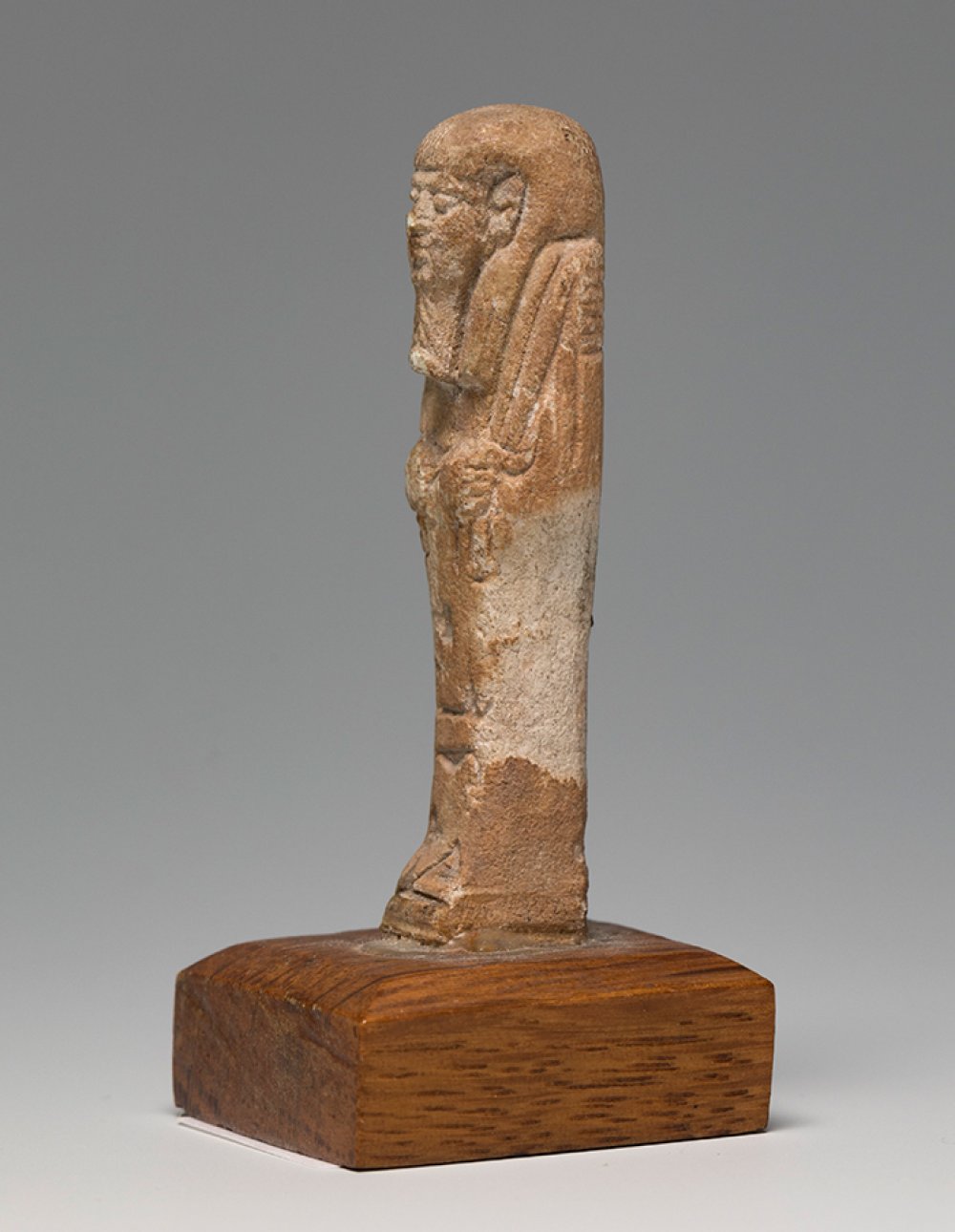 Ushebti; Egypt, Lower Egypt, Ptolemaic period, 2nd-1st century BC.Brown faience. Wooden base. - Image 2 of 4