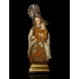 Virgin of Mount Carmel, XIX century.Carved and polychrome wood. Silk and velvet vestments enriched