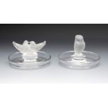 Lalique. France, second half of the 20th century.Two ashtrays, model "Rapace" and "Colombe",