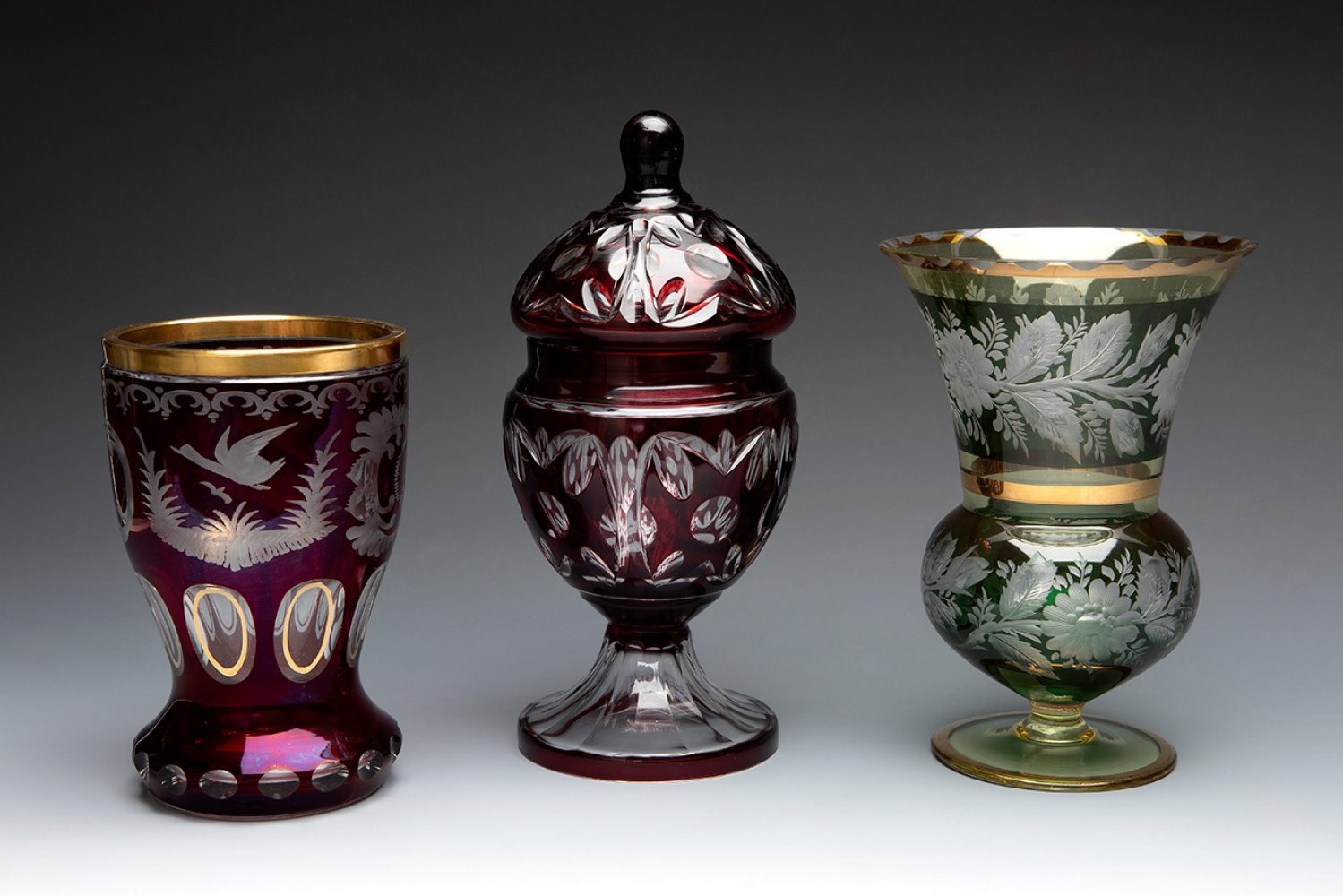 BOHEMIA. Czechoslovakia, second half of the 20th century.Two vases and a bonbonniere.In cut glass.