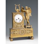 Table clock, Empire period. France, early 19th century.Gilt bronze.The pendulum and the key are