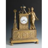 Empire table clock. France, early 19th century.Gilt bronze.The pendulum is missing.The machinery