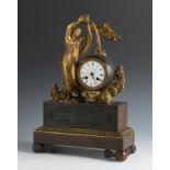 Empire table clock. France, early 19th century.Patinated and gilded bronze.In need of restoration.