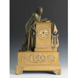Empire table clock. France, early 19th century.Gilt bronze.The pendulum is missing.The machinery