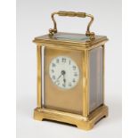 Travel clock, 19th century.Bronze and bevelled glass.Key preserved.Measurements: 13 x 8 x 7 cm.