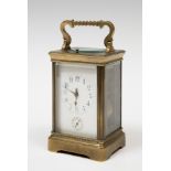 Travel clock; late 19th century.Bronze and bevelled glass.No key preserved.Measurements: 16 x 9.5