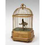 Cage with bird; late 19th century.Bronze, feathers, stuccoed wood and brass.In need of restoration