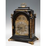 Bracket clock, following models from the first half of the 18th century.Ebonised wood and gilt