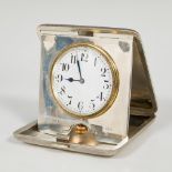 Travel alarm clock; early 20th century.Silver.Silver frame and case.Damaged dial.It has a