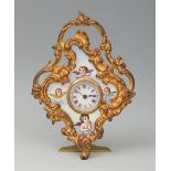 Table clock. Vienna. Late 19th century, Louis XV style. Gilt bronze and enamel. White dial, Roman