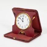 Travel alarm clock; late 19th - early 20th century.Red dyed leather case.Measurements: 10 x 10,5