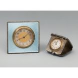 Set of two travel clocks. England, ca. 1900. Silver, bronze and enamel. White dials, Arabic