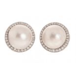 Pair of earrings made in 18 kt white gold, with half a Japanese pearl trimmed with 100 brilliant-cut