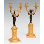 Pair of Napoleon III candlesticks, mid XIX century.Gilded and blued bronze.Measurements: 41,5 x 18 x