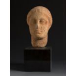 Greek female head, 6th century BC.Marble.Provenance: Private collection of Columbia University
