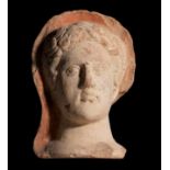Male votive head. Etruria, circa 3rd century BC.Terracotta.Damaged, slight cracks on the face.