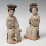 Pair of seated fat ladies; China, Tang Dynasty, AD 618-907.Polychrome terracotta.