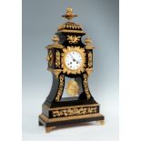 19th century table clock.Bronze, ebonised wood and porcelain dial.Measurements: 66 x 34 cm.Table