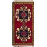 Turkestan carpet, mid-20th century.Hand-knotted in wool. It has a red field with medallions and