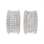 Pair of half Creole earrings in 18kts. white gold. Frontis domed with princess-cut diamonds and