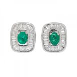 Pair of earrings in 18kt white gold. Rosette model with central oval-cut emerald, set in claws and