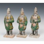 Three soldiers; China, Mig Dynasty, AD 1368-1644.Terracotta with engobes and Sankai glaze.
