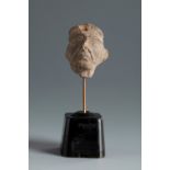 Grotesque head. Smyrna, 4th-3rd century BC.Terracotta.Provenance: Smyrna, 1895-1905. Collection Paul