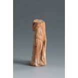 Headless female figure holding a chiton. Smyrna, 4th-3rd century BC.Terracotta.Provenance: Smyrna,