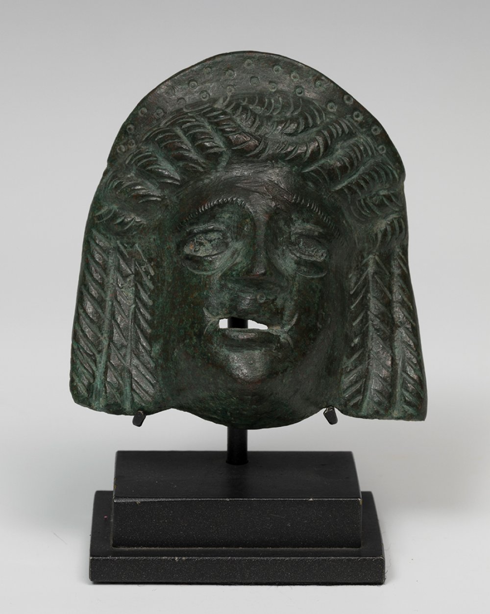 Theatre-mask applique; Rome, 2nd century AD.Bronze.Slightly missing from the forehead.Provenance: - Image 4 of 5