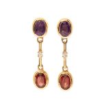 Pair of long earrings in 18kt yellow gold. Button with oval amethyst mounted in chaton from which