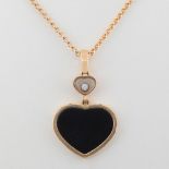 CHOPARD. Happy Hearts pendant in 18kt rose gold and heart-shaped onyx as the centrepiece. It hangs