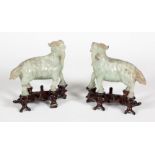 Pair of figures. China, early 20th century.Hard stone with carved wooden base.Size: 8 x 10 x 4 cm;