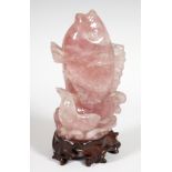 Hard stone carving. China, early 20th century.Pink hard stone with carved wooden base.