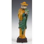 Figure of a monk. China, early 19th century.Stoneware and carved wooden base.Measurements: 51 x 14 x