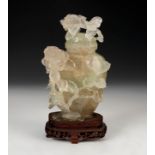 Potiche with flowers. China, 20th century.Hand carved fluorite on wooden base.Size: 16 cm (