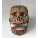 Mexican school; circa 1800."Skull.Silver alloy with garnets, emeralds and hard coloured stones.