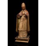 Spanish school, 17th century."Saint Gregory the Great".Polychrome wood.The pedestal bears the