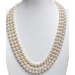 Necklace with three strands of 8 mm cultured pearls. in diameter and 18 kt gold closure, with ruby