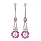 Pair of long earrings with movement in platinum, rubies and diamonds. Model with three parts and