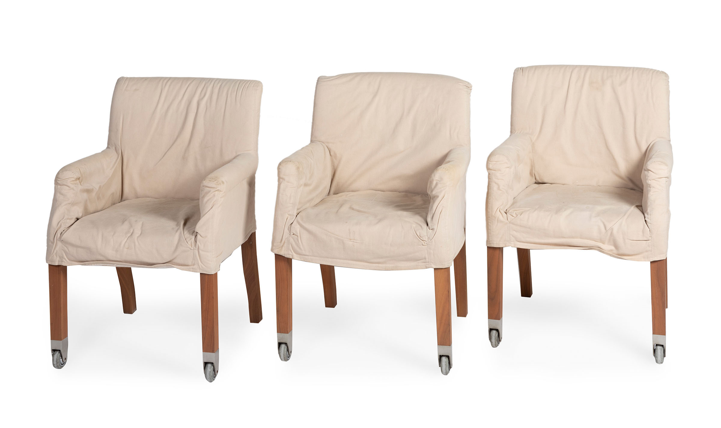 Three Chairs. Flexform, Italy.Wood.Bone coloured fabric covers.Measurements: 81 x 55 x 60 cm.Three