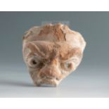 Fragment of a theatrical mask. Smyrna, 3rd century BC.Terracotta.Provenance: Smyrna, 1895-1905.