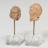 Pair of heads; Greece, Hellenistic period, 3rd century BC.Terracotta.Damage caused by the passage of