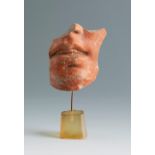 Fragment of a satyr's head. Smyrna, 3rd century BC.Polychrome terracotta.Provenance: Smyrna, 1895-
