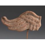 Fragment of the wing of a figure of Nike. Smyrna, 3rd century BC.Terracotta.Provenance: Smyrna,