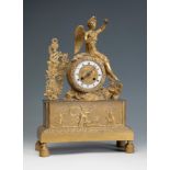 Table clock, Empire period. France, early 19th century.Gilt bronze.Some lack in the figure.The