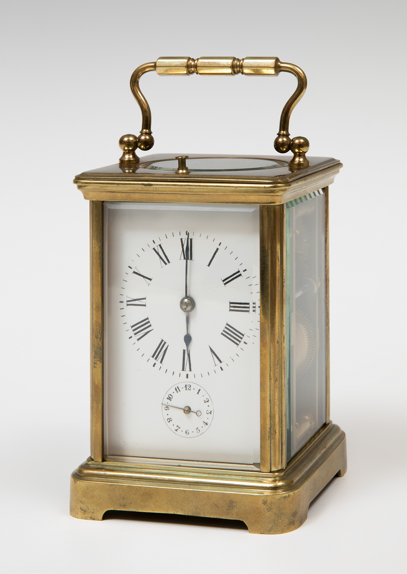 Travel clock; late 19th century.Bronze and bevelled glass.No key preserved.Precise set-up.