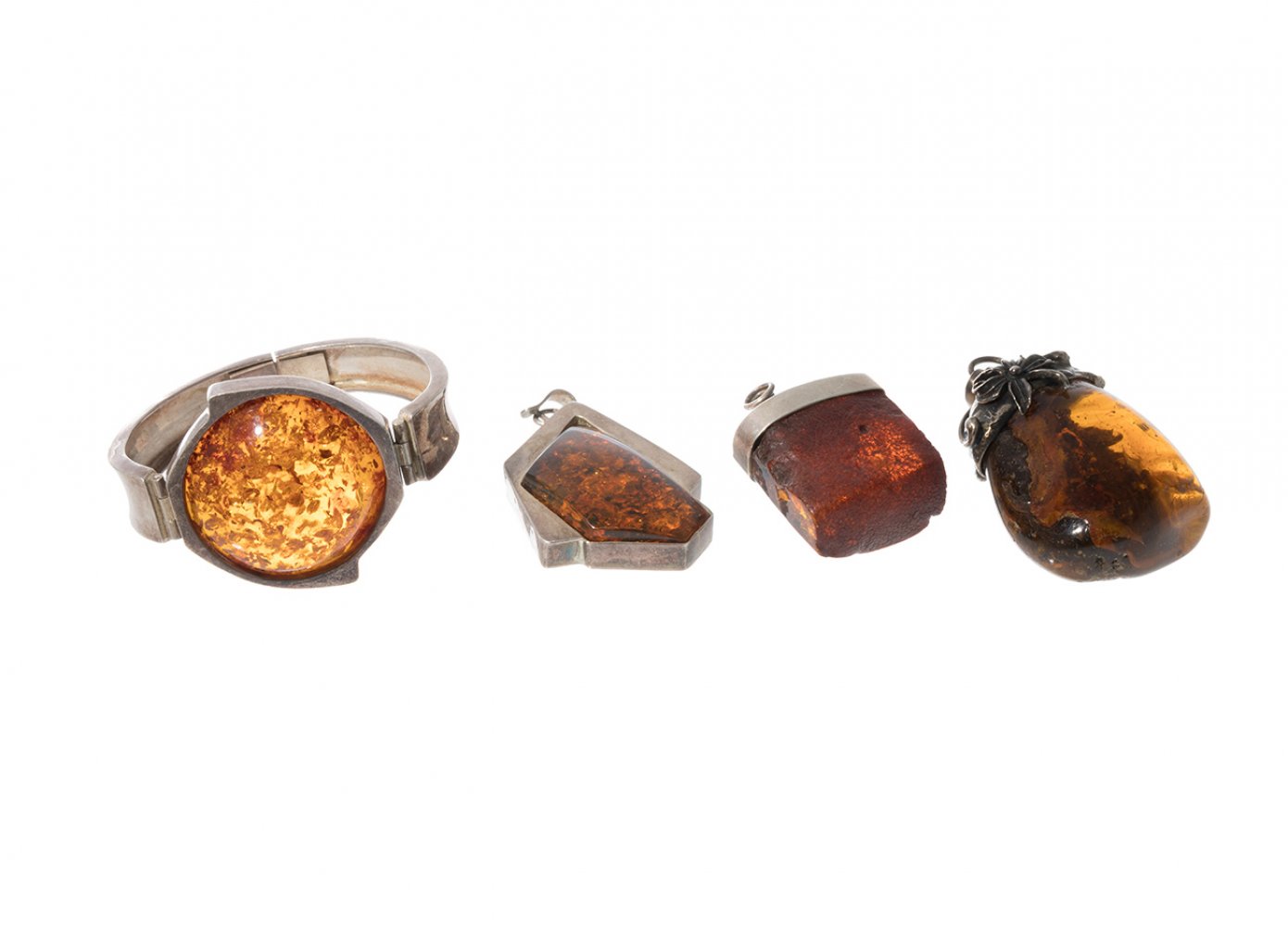 Set of three amber pendants and bracelet. Pendants with silver frames and silver clasps. Bracelet
