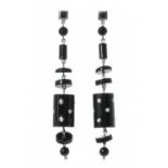 Pair of long earrings with movement in 18kt white gold. Model with onyx pieces dotted with